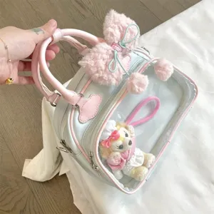 Pastel blue ita bag detail with transparent window, cute plush doll and fluffy bow accessory.