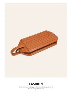 Brown leather geometric cosmetic pouch detail, stylish folding design with portable handle.