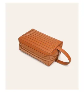 Brown geometric travel cosmetic bag, portable waterproof toiletry organizer with handle.