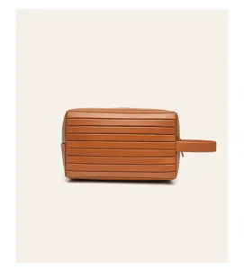 Brown travel toiletry bag detail view, portable cosmetic pouch with handle for daily use.