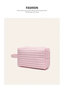 Pink cosmetic makeup bag detail, portable travel toiletry pouch with horizontal ribbed design.