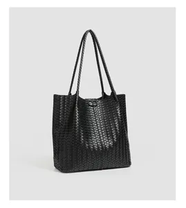 Detailed view of the black woven leather tote bag showing intricate intrecciato texture.