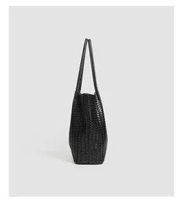 Black woven leather tote bag detailed view, showcasing premium texture and large capacity.