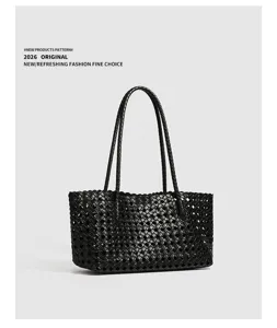 Classic black woven leather shoulder bag for women, vintage minimalist design, stylish tote purse.