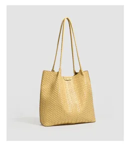 Yellow woven leather tote bag detailed view, showcasing premium texture and large capacity.