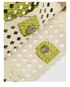 Green woven leather shoulder bag detail with geometric cutouts and metal magnetic closure.