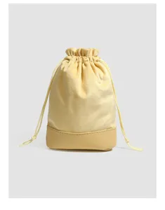 Yellow velvet leather spliced jewelry pouch drawstring dustproof bag portable storage.