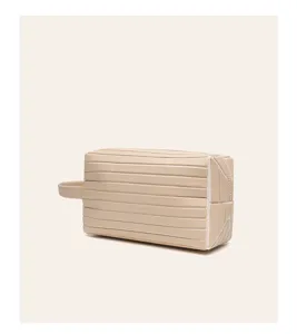 Travel cosmetic bag detail showing the durable waterproof leather and horizontal stripe texture.