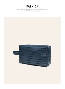 Detailed view of dark blue travel toiletry bag with parallel groove texture and handle.