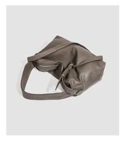 Close-up detail of the minimalist soft leather women shoulder bag, highlighting texture and strap.