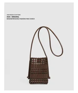 Stylish brown leather cutout crossbody phone bag, casual minimalist design for summer.