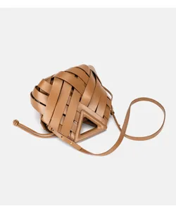 Brown woven leather handbag detail featuring a unique triangular handle and fine strap texture.