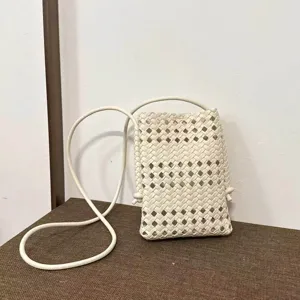 White woven leather crossbody phone bag detail, hollow grid design with slim strap.