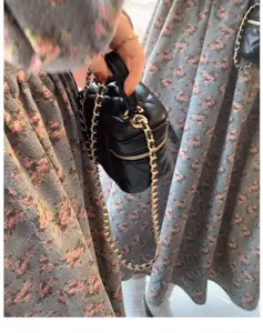 Black quilted mini handbag with chain strap, detailed view showing craftsmanship and elegant style