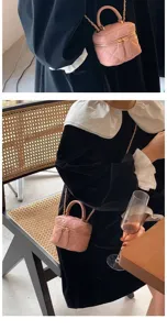Detailed lifestyle shot of a pink quilted mini chain crossbody bag, showing texture and wear.