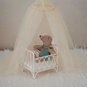 Miniature dollhouse furniture set with lovely mouse plush toy and canopy bed for decor.