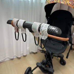 Primer plano de ganchos para carrito con correas de cuero PU y mosquetones metálicos.