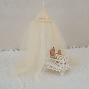 Miniature dollhouse scene detail showing a cute tiny bed with yellow canopy and cute plush.
