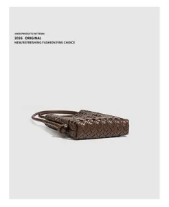 Detail view of brown woven leather shoulder bag, soft texture and chic knotted strap design.