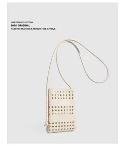 Detailed view of the woven leather mini cross-body phone bag with soft material and strap.