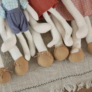 Close-up detail of Nordic style long-eared plush rabbit fabric doll, exquisite craftsmanship.