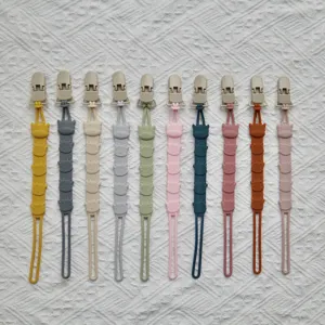 Silicone baby pacifier clip chain with cute cartoon cow design, food grade baby accessory detail.