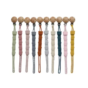 Silicone pacifier clips set with wooden beads and cute cartoon cow design for babies.