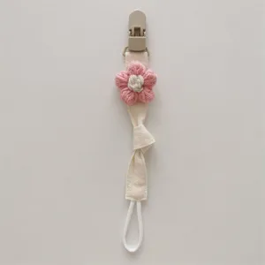 Handcrafted knitted flower pacifier clip detail, soft fabric baby teether chain view.