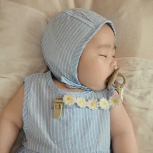 Cute daisy baby pacifier chain with cute striped infant clothing detail showcase.