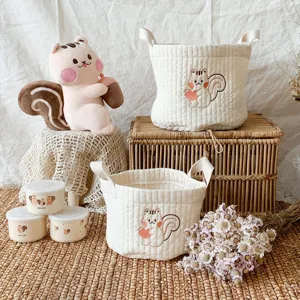 Quilted cotton storage basket with cute animal embroidery for cozy home organization.