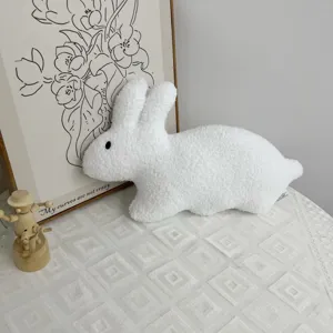 Soft white plush bunny toy detail, featuring fluffy textured fabric and cute long ears.