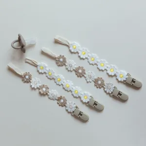 Closeup of embroidered daisy baby pacifier chain details, cute floral design for toddlers.