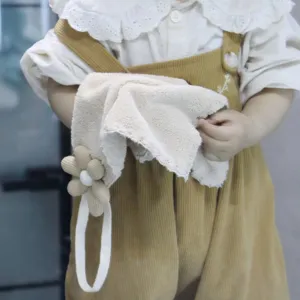 Close-up detail of soft hanging hand towel with cute flower loop, highly absorbent material.