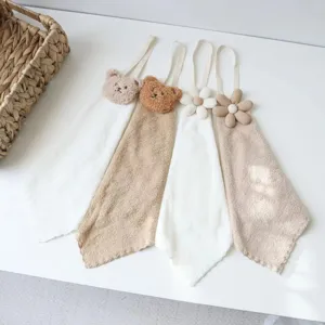 Detailed close-up view of cute Korean style bear and flower hanging hand towels for kitchen.