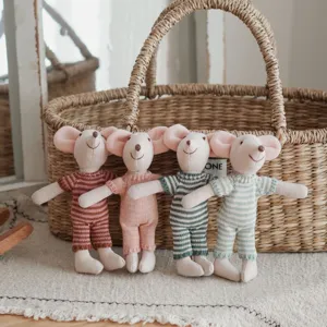 Charming knitted mouse dolls with striped outfits, perfect for children room decor and play.
