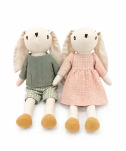 Detail shot of cute cotton linen floppy ear bunny dolls with removable outfits and plaid dresses.