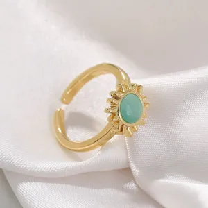 Detailed view of the elegant gold plated sunflower ring with green cat eye gemstone.