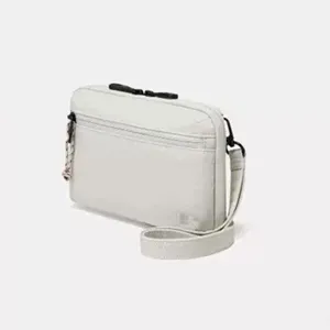 Compact grey crossbody passport wallet featuring front zip pocket and sleek shoulder strap.