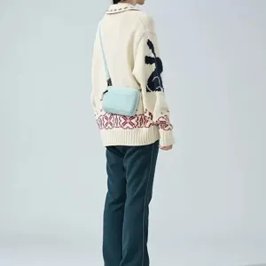 Detail view of the mini crossbody square bag showcasing compact design and convenient wear.