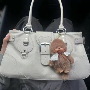 Y2K retro style light grey tote bag detail, featuring metal buckle and cute plush doll pendant.