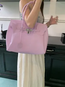 Large capacity purple PVC jelly tote bag, stylish shoulder handbag with metal lock hardware.
