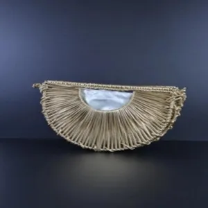 Detailed view of the handmade woven crescent bag, showing intricate straw texture and inner lining.