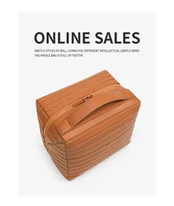Fashionable brown striped cosmetic bag with large capacity, durable leather storage pouch.