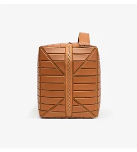 Brown geometric panel cosmetic bag with zipper closure and top handle for practical use.