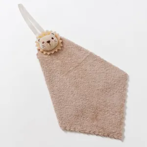 Detail view of hanging hand towel with plush animal decoration and soft absorbent fabric.