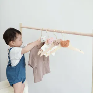 Cute wooden clothes hangers with plush bear heads for kids room organization and nursery decor.