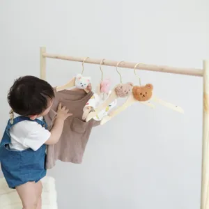Cute wooden clothes rack with plush bear heads for baby kids clothing storage and display details.