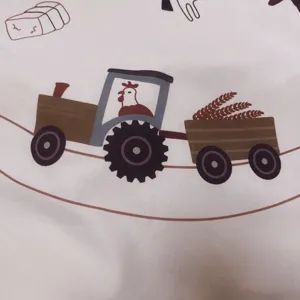 Close-up detail of cute farm tractor print on baby crawling mat for kids room decor