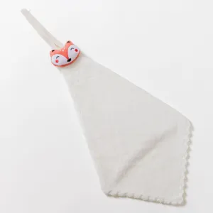 Close-up detail of hanging hand towel with cute plush animal decor, soft absorbent material.