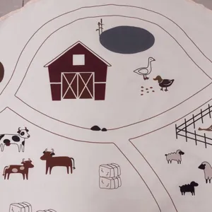 Close-up detail of cute farm animal print baby crawl mat, soft nursery rug for kids playing.